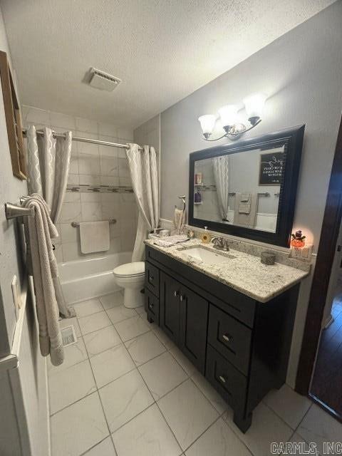 full bathroom featuring shower / tub combo, vanity, a textured ceiling, tile patterned flooring, and toilet