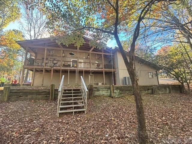 rear view of property featuring a wooden deck