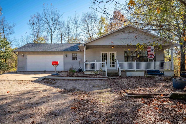 view of front of home with covered porch and a garage