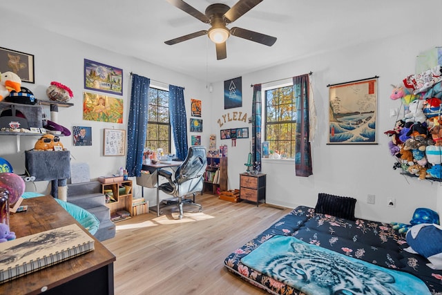 bedroom with ceiling fan and light wood-type flooring