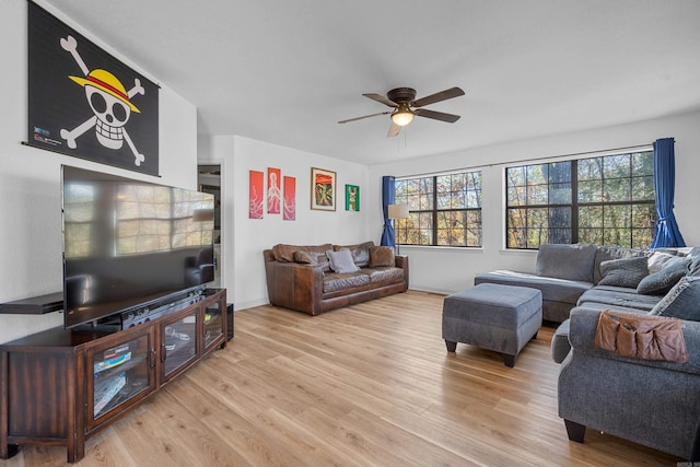 living room featuring light hardwood / wood-style flooring and ceiling fan