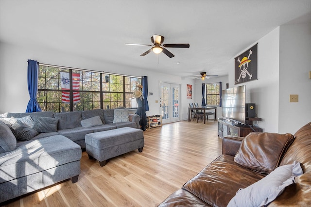 living room with light hardwood / wood-style flooring and ceiling fan