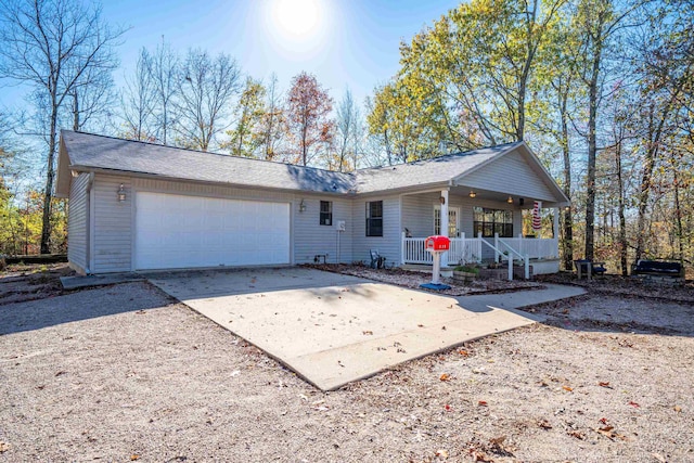 ranch-style house with a porch and a garage