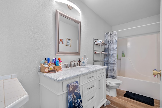 full bathroom with hardwood / wood-style floors, vanity, toilet, and shower / tub combo with curtain