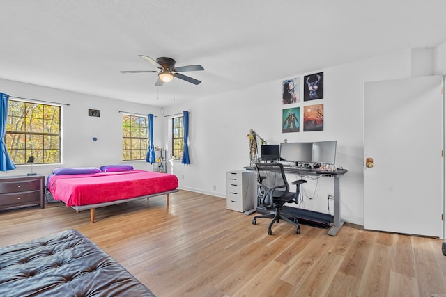 bedroom with ceiling fan and light hardwood / wood-style flooring