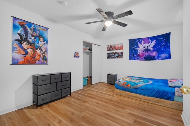 bedroom with hardwood / wood-style floors, a closet, and ceiling fan