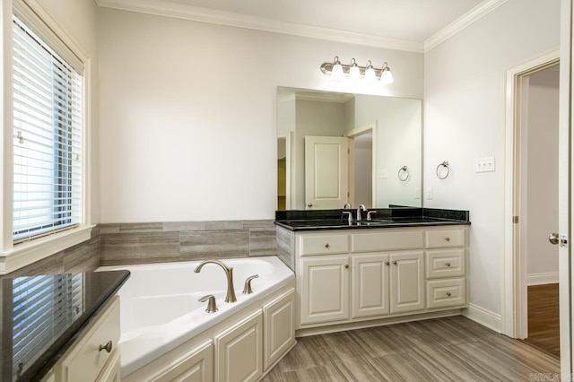 bathroom featuring hardwood / wood-style flooring, vanity, crown molding, and a tub