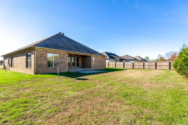 back of house with a yard