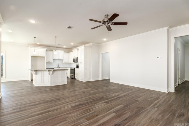 kitchen with white cabinetry, dark wood-type flooring, decorative light fixtures, a kitchen island, and appliances with stainless steel finishes