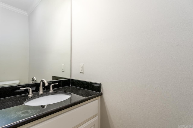 bathroom with crown molding, vanity, and toilet