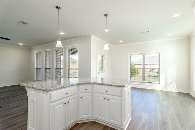 kitchen with white cabinets, hardwood / wood-style floors, a center island, and hanging light fixtures