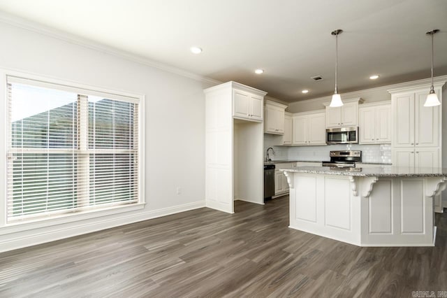 kitchen featuring white cabinets, hanging light fixtures, dark hardwood / wood-style floors, light stone countertops, and stainless steel appliances