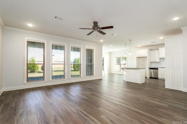 unfurnished living room with crown molding, ceiling fan, dark hardwood / wood-style flooring, and a healthy amount of sunlight