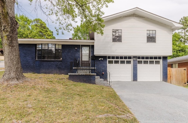 tri-level home with a front yard and a garage