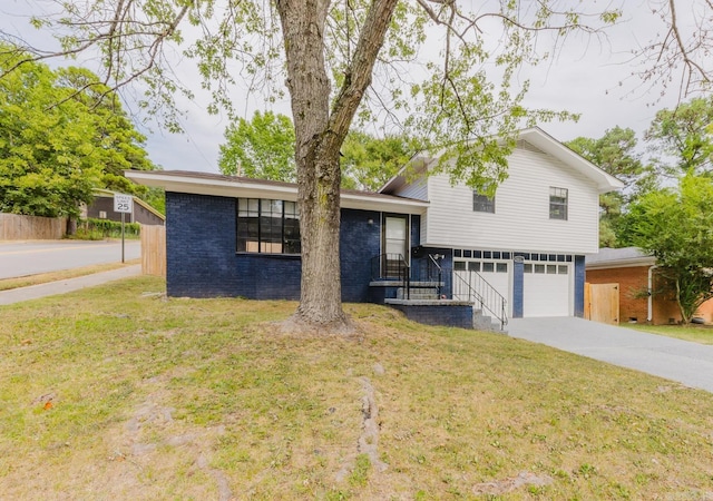 tri-level home with a front yard and a garage