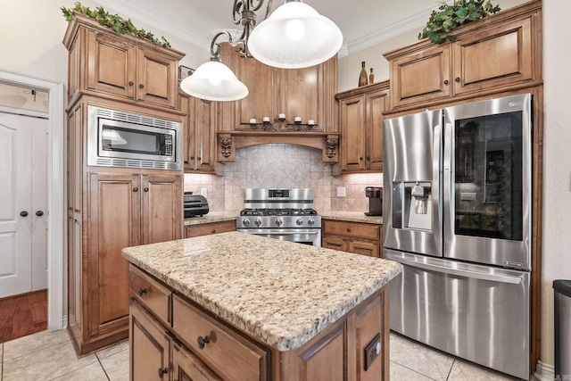 kitchen with crown molding, a center island, stainless steel appliances, and decorative light fixtures