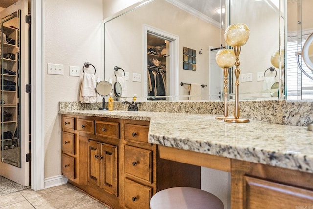 bathroom with tile patterned flooring, vanity, and ornamental molding