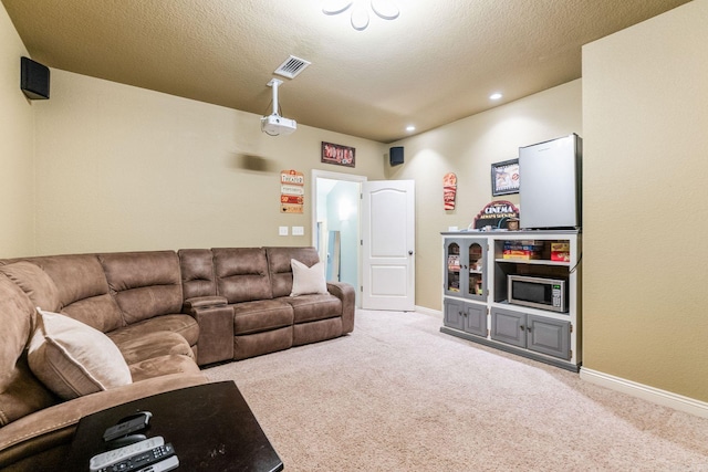 carpeted living room featuring a textured ceiling