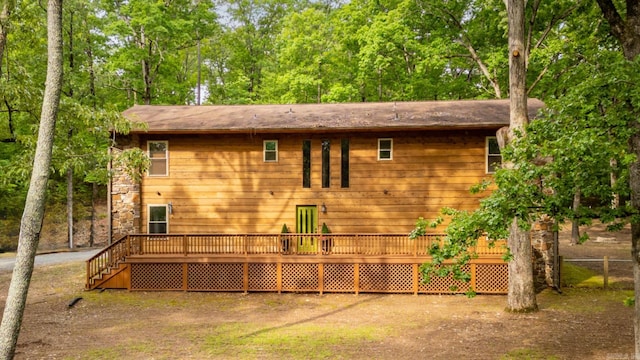 back of property featuring a wooden deck