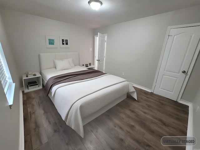 bedroom with dark hardwood / wood-style flooring