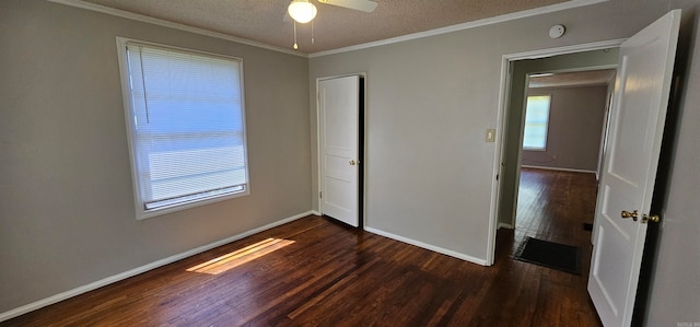 unfurnished bedroom with ceiling fan, dark hardwood / wood-style flooring, crown molding, a textured ceiling, and a closet