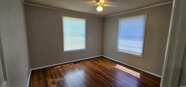 spare room with ceiling fan, plenty of natural light, dark wood-type flooring, and ornamental molding