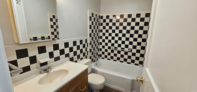 full bathroom with vanity, toilet, tub / shower combination, and tile walls