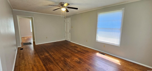 spare room with a textured ceiling, ceiling fan, ornamental molding, and dark wood-type flooring