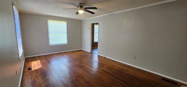 spare room featuring a textured ceiling, crown molding, ceiling fan, and dark wood-type flooring