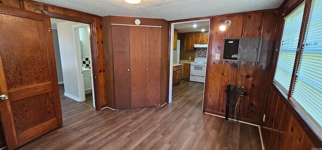 kitchen featuring decorative backsplash, dark hardwood / wood-style flooring, a textured ceiling, and white electric range