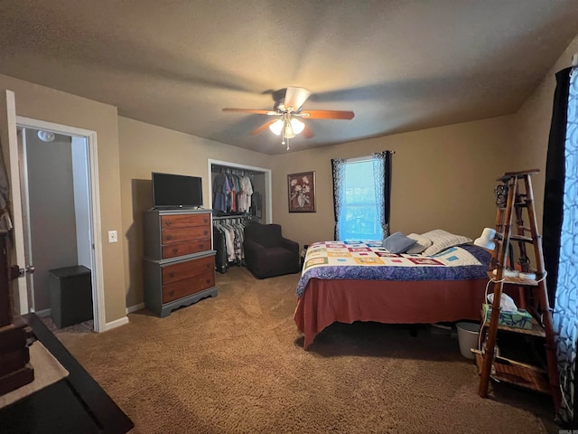 bedroom with carpet flooring, ceiling fan, a closet, and a textured ceiling