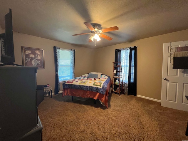 carpeted bedroom with ceiling fan and a textured ceiling