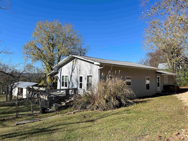 view of side of property with a lawn