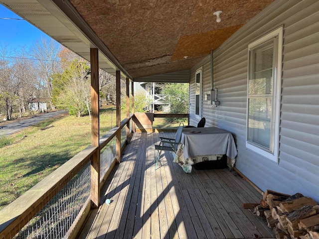 deck with covered porch, a yard, and grilling area