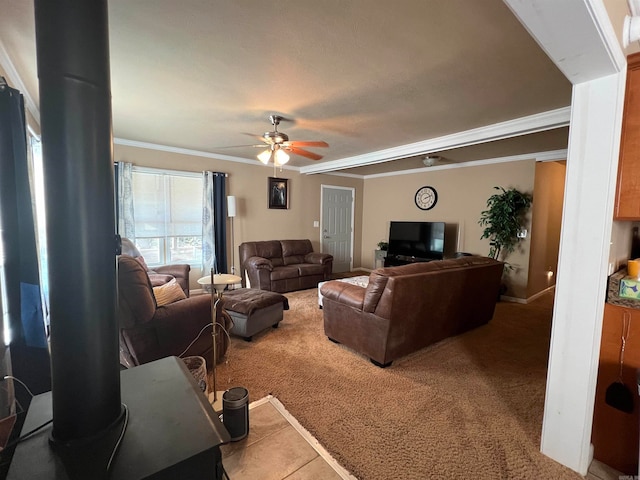 carpeted living room with ceiling fan and ornamental molding