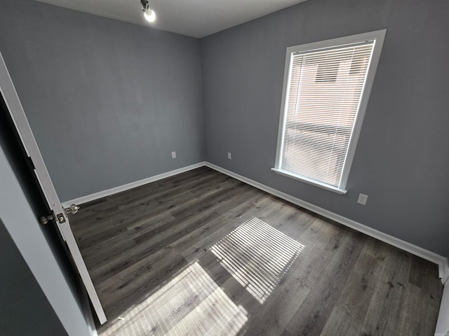 empty room with dark wood-type flooring