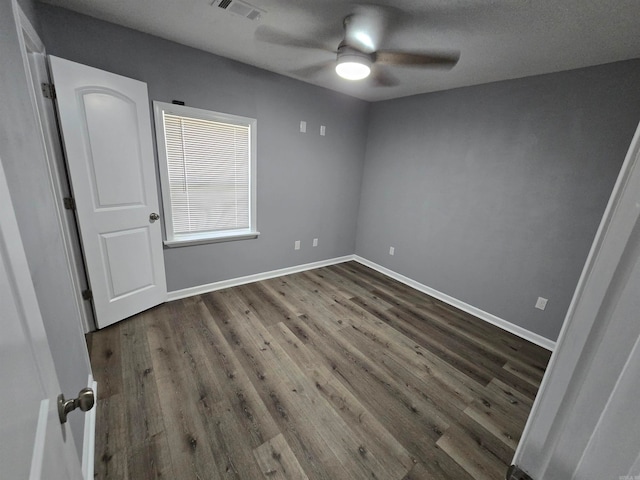 unfurnished room featuring a textured ceiling, ceiling fan, and dark hardwood / wood-style floors