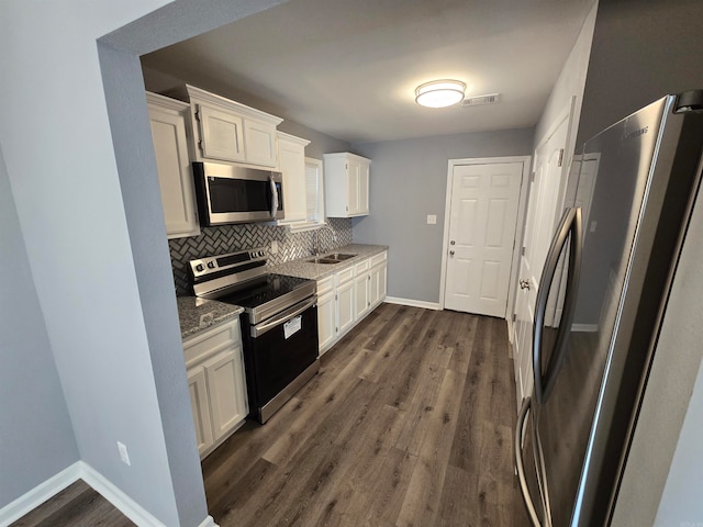 kitchen featuring light stone countertops, dark wood-type flooring, white cabinets, and stainless steel appliances