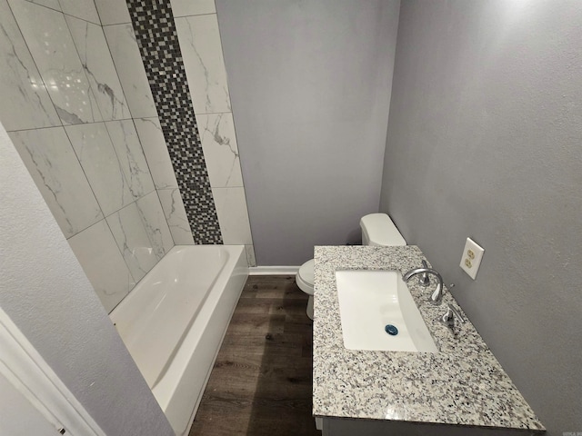 bathroom featuring hardwood / wood-style floors, vanity, and toilet