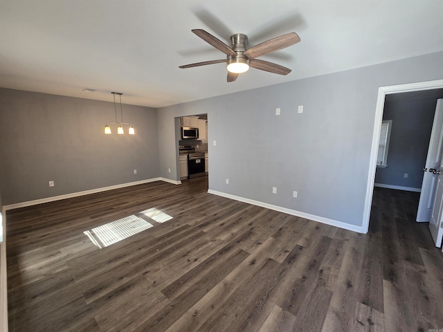 unfurnished living room featuring ceiling fan and dark hardwood / wood-style flooring