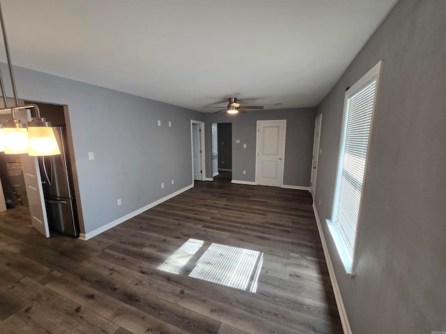 unfurnished living room with dark hardwood / wood-style floors and ceiling fan