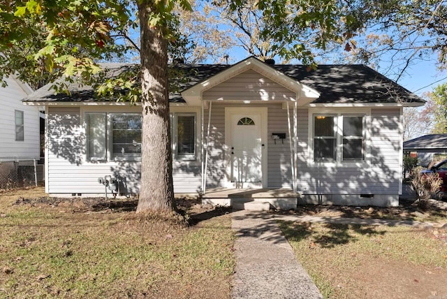 bungalow-style home featuring a front lawn