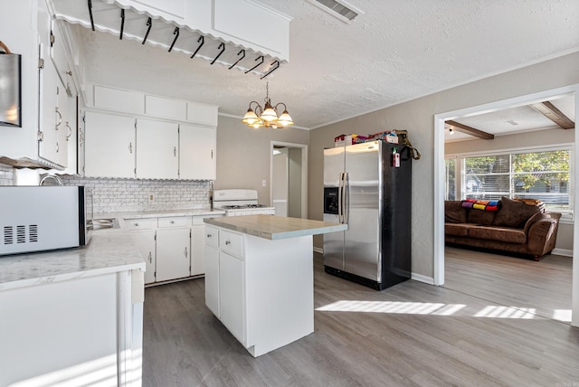 kitchen featuring hardwood / wood-style floors, pendant lighting, a center island, white cabinets, and stainless steel fridge with ice dispenser