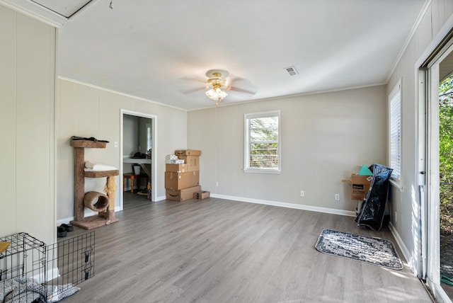 interior space featuring crown molding, ceiling fan, and hardwood / wood-style flooring