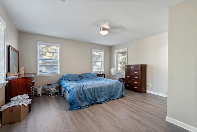 bedroom with light hardwood / wood-style flooring and ceiling fan