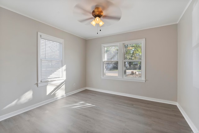 empty room featuring hardwood / wood-style floors, ceiling fan, and crown molding