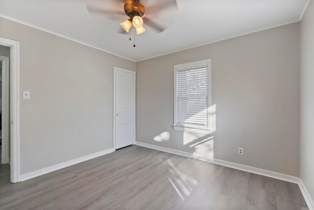 empty room with ceiling fan, ornamental molding, and light hardwood / wood-style flooring