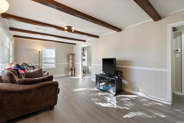 living room with beamed ceiling and hardwood / wood-style floors