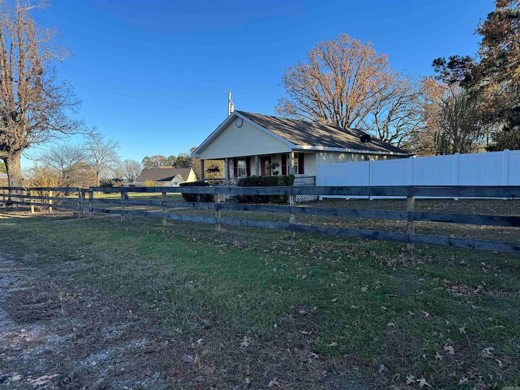 back of house with a lawn