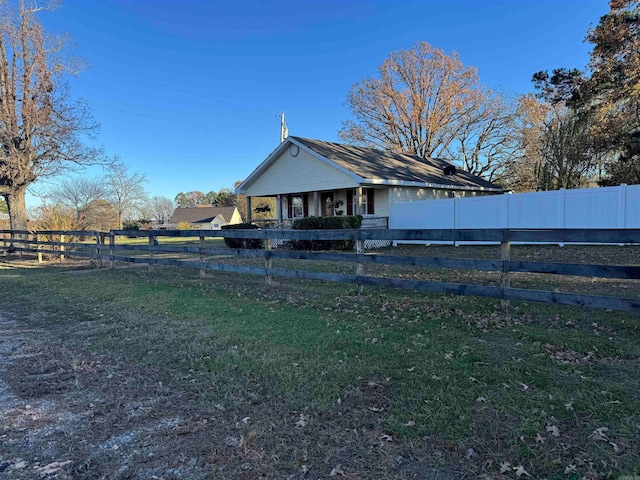 back of house with a lawn